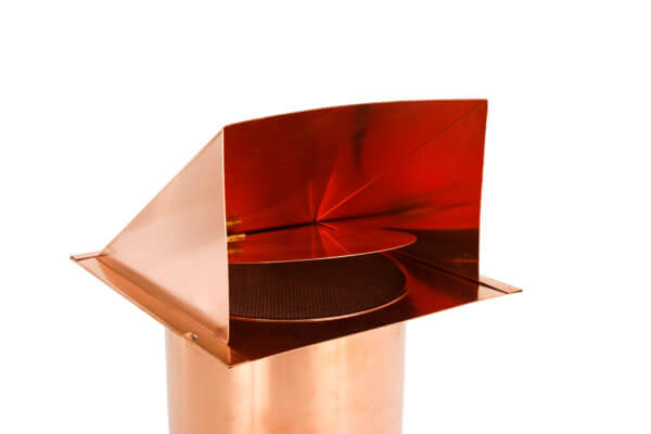 Inside view of hooded wall vent with screen and damper in copper.