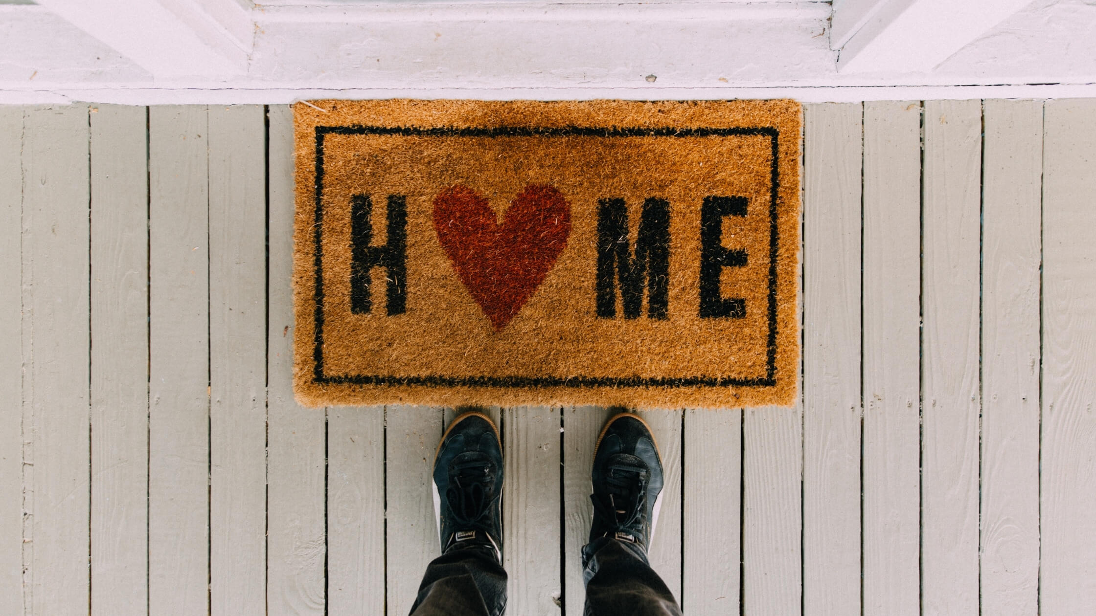 welcome mat with man standing over it home